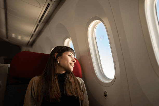 A passenger looking through an aircraft window